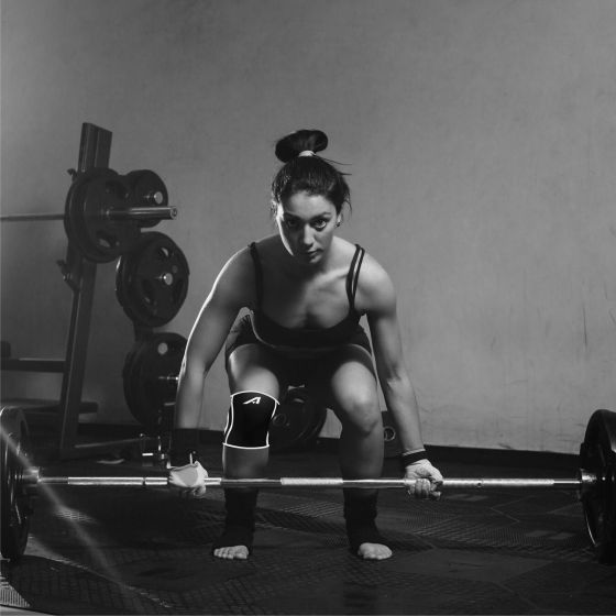female weightlifter wearing an Affinity Neoprene Compression Knee Sleeve
