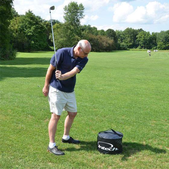 player swinging club at an Intech Golf Impact Bag