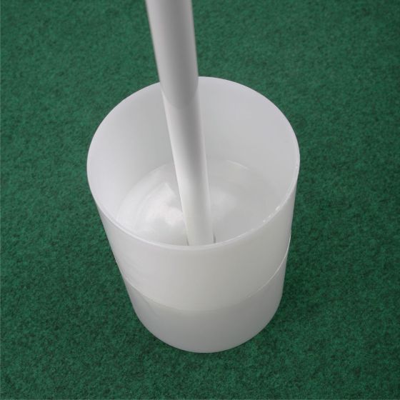 Inserting the Tour Gear Portable Golf flag pole into cup